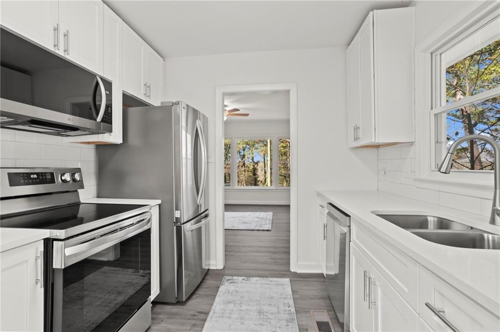 502 Alpine Way Marietta, GA 30062 - Photo 12 of 21 a kitchen with stainless steel appliances granite countertop a refrigerator and a sink