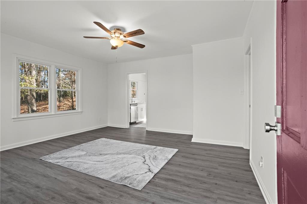 502 Alpine Way Marietta, GA 30062 - Photo 5 of 21 a view of an empty room with wooden floor and a ceiling fan