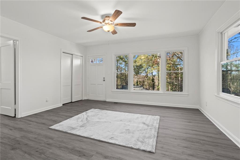 502 Alpine Way Marietta, GA 30062 - Photo 8 of 21 an empty room with wooden floor chandelier fan and windows