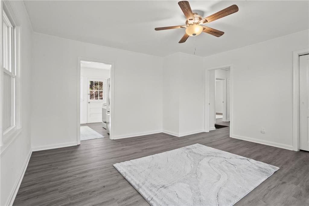 502 Alpine Way Marietta, GA 30062 - Photo 9 of 21 an empty room with wooden floor ceiling fan and window