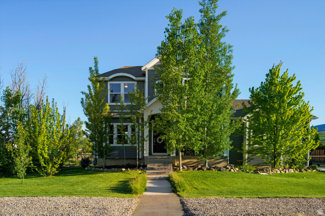 681 Island Road Morgan, UT 84050 - Photo 36 of 49 Two-story home with dark gray siding, white trim, and a prominent front entrance