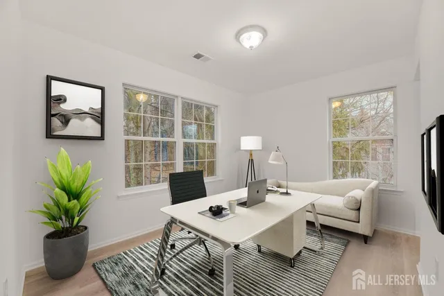 a living room with furniture potted plant a window and a potted plant