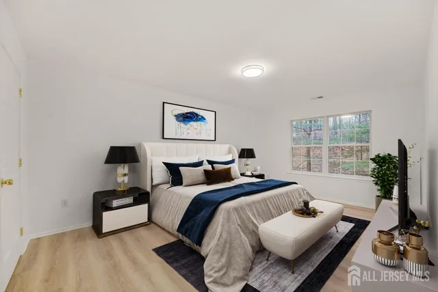 a bedroom with bed and a large window