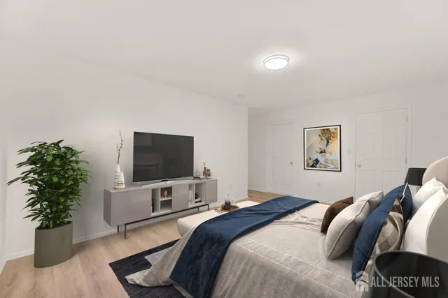 a bedroom with a bed and a flat screen tv