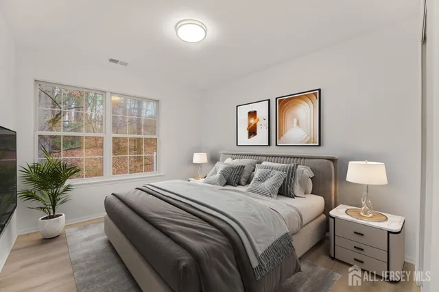 a bedroom with a bed and a potted plant