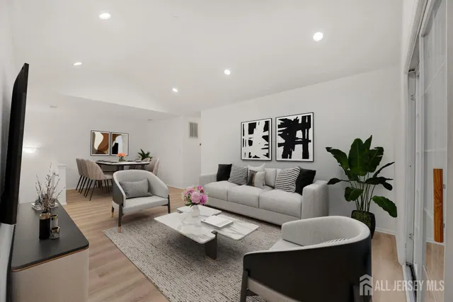 a living room with furniture and a potted plant