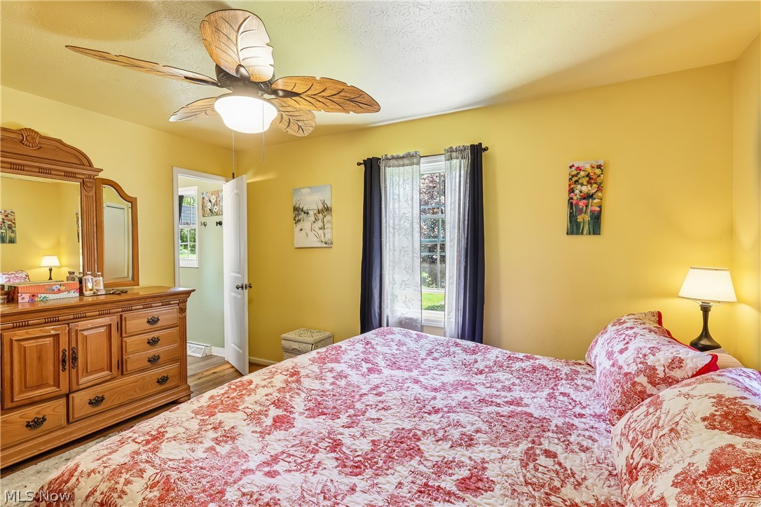 6109 North Oval Road Clinton, OH 44216 - Photo 19 of 47 Primary bedroom with ceiling fan / light, double closet and wood flooring