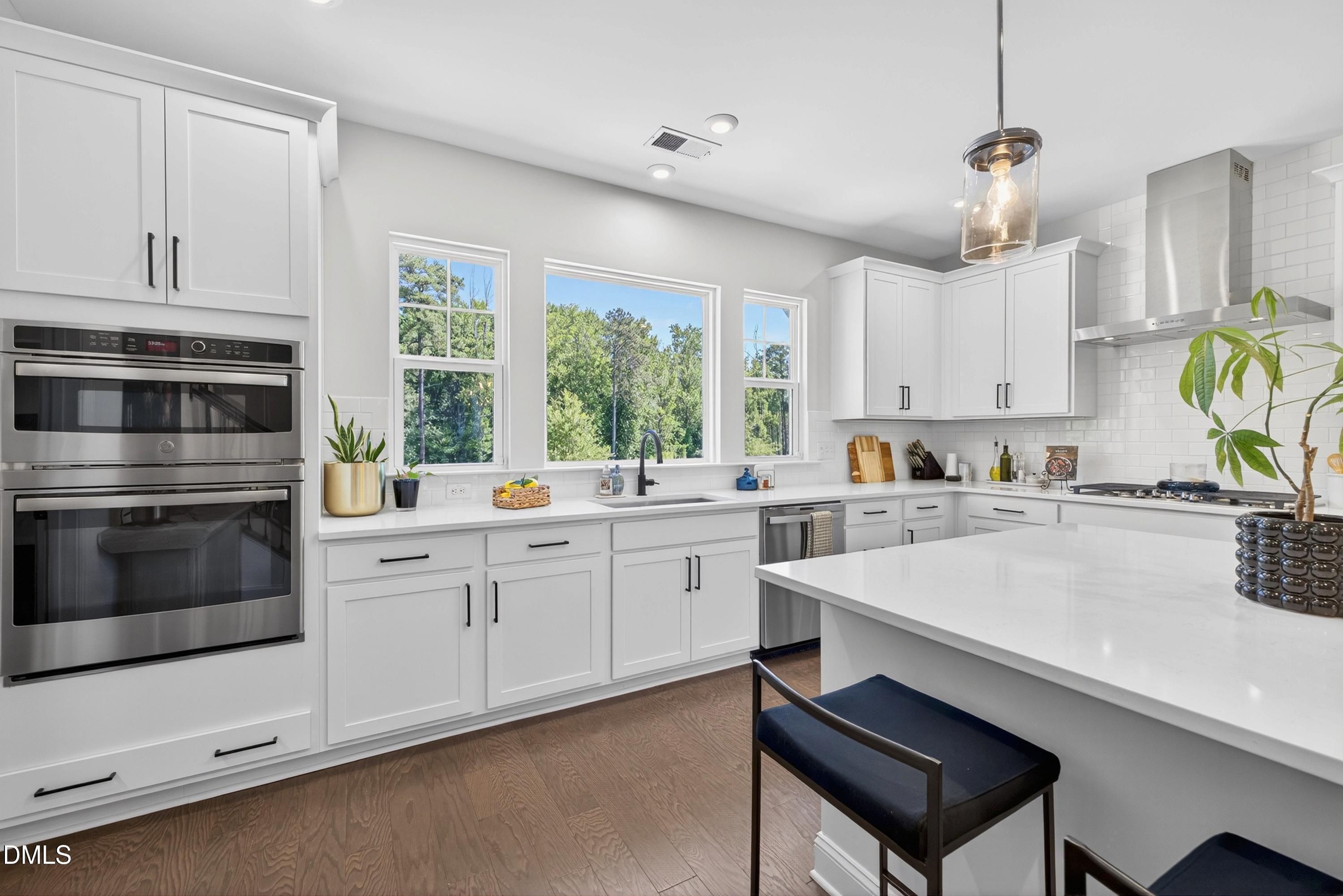 1063 Danvers Loop Apex, NC 27523 - Photo 27 of 67 a kitchen with white cabinets and white appliances
