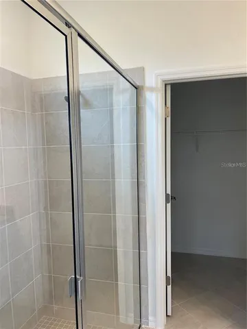 a bathroom with a glass shower door
