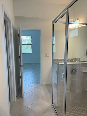 a bathroom with a glass shower door