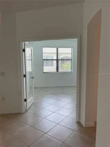 an empty room with a empty space and windows