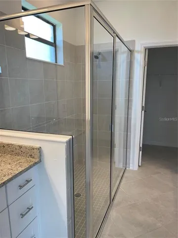 a bathroom with a shower and vanity