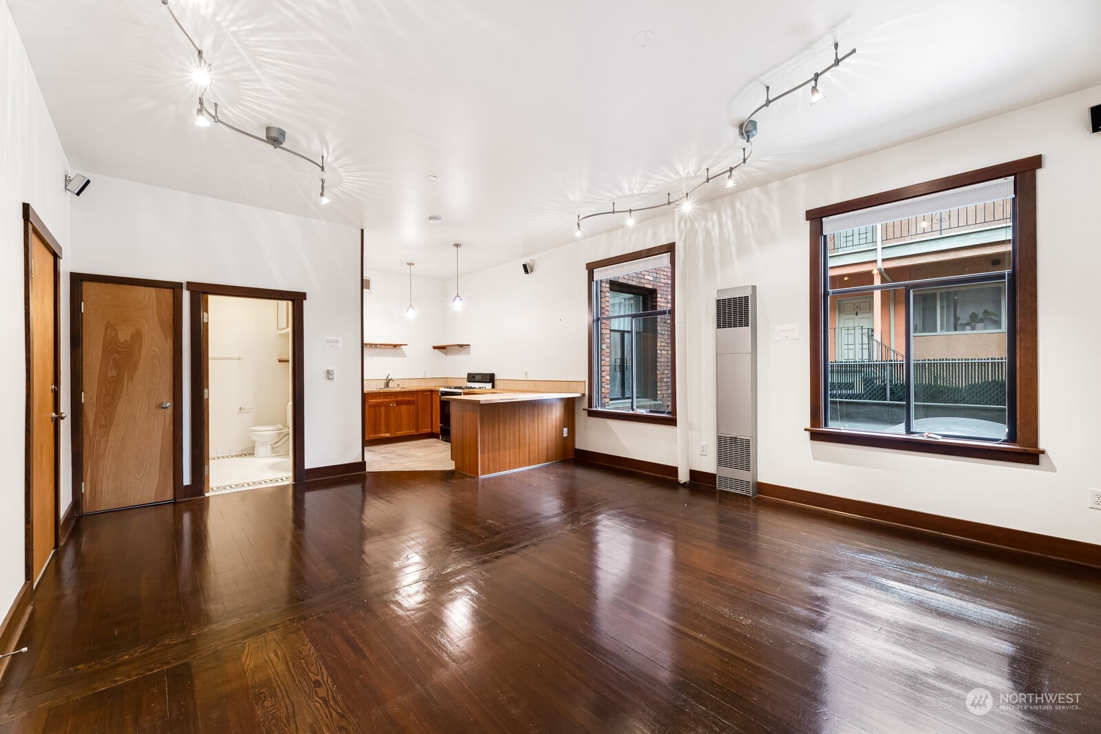 22 John Street, Unit 6 Seattle, WA 98109 - Photo 5 of 17 a view of an empty room with wooden floor and a window