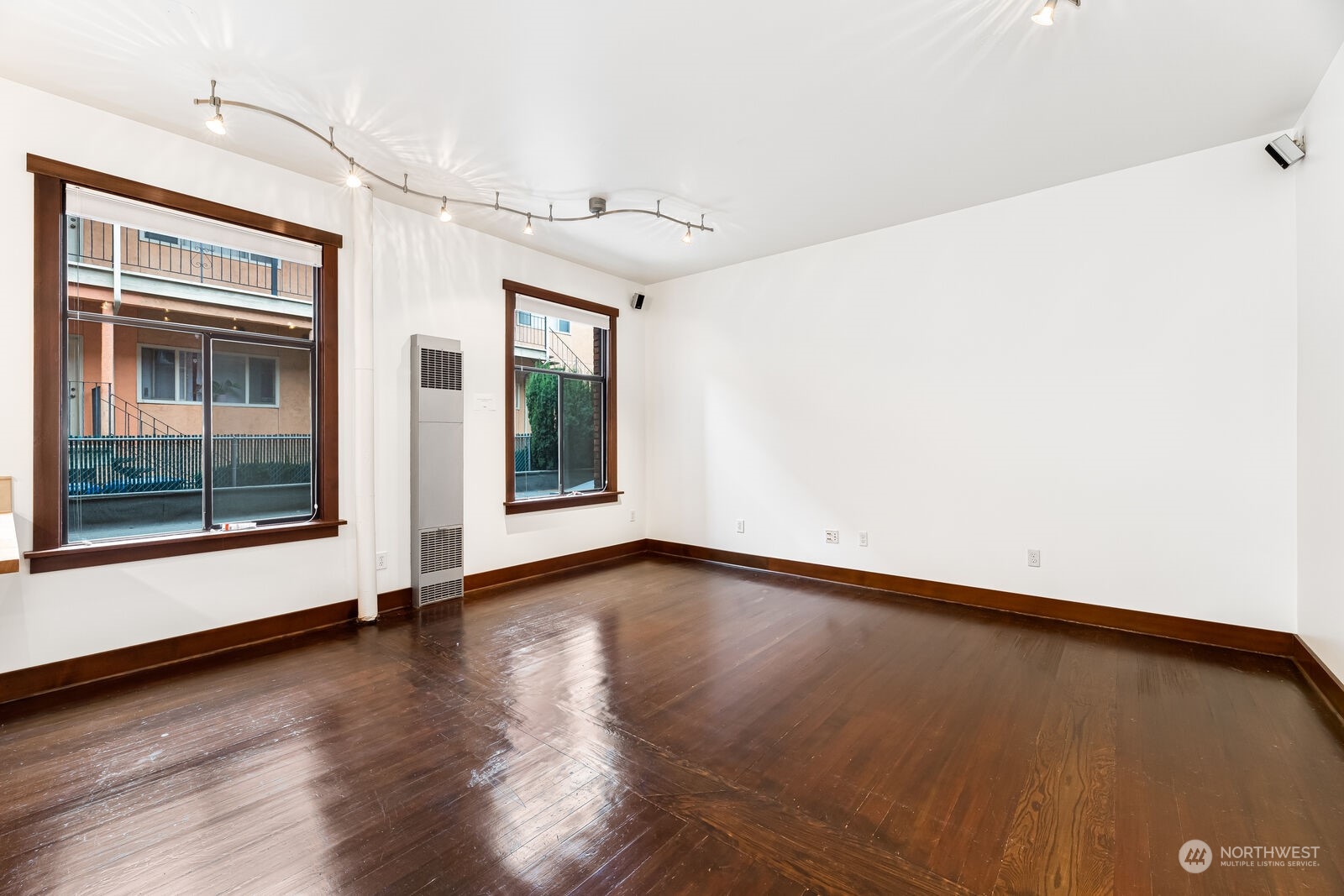 22 John Street, Unit 6 Seattle, WA 98109 - Photo 7 of 17 a view of an empty room with a window and wooden floor