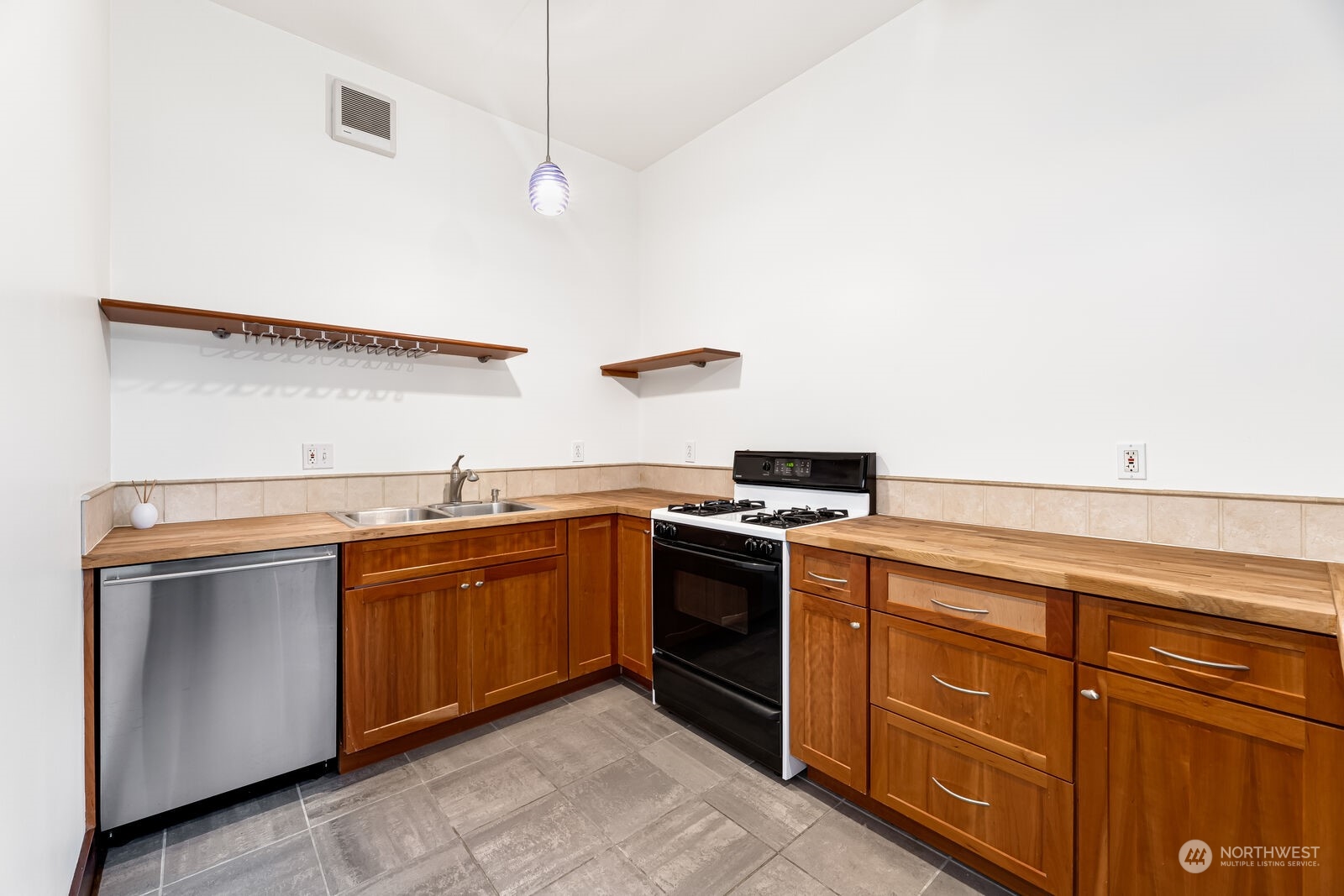 22 John Street, Unit 6 Seattle, WA 98109 - Photo 9 of 17 a kitchen with stainless steel appliances granite countertop a stove and a sink