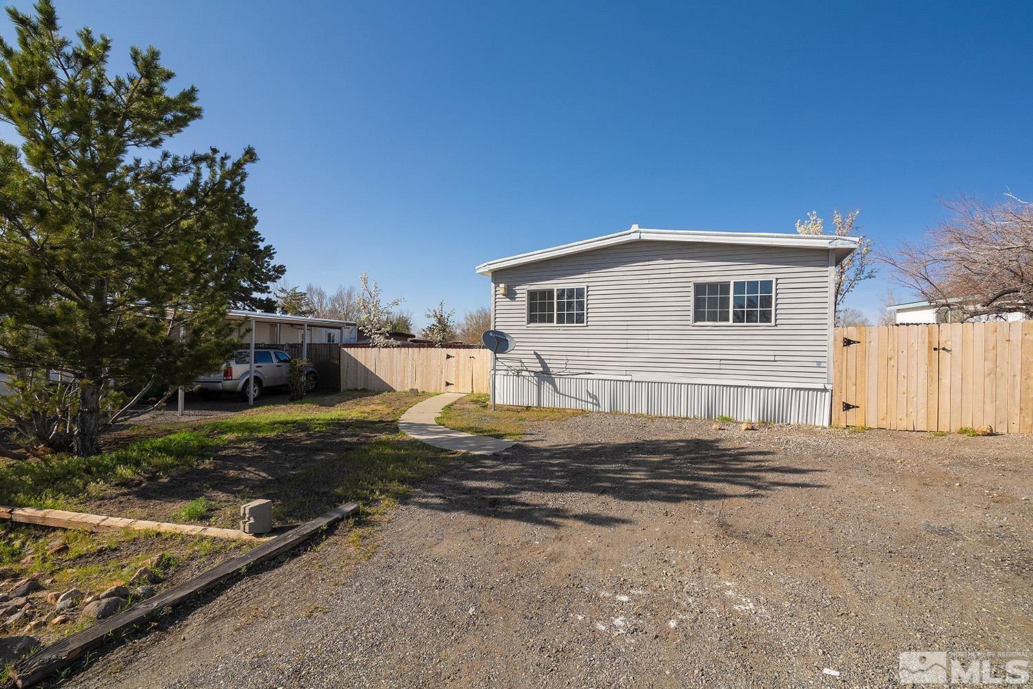 16310 Enargite Circle Reno, NV 89521 - Photo 22 of 32 a backyard of a house with yard and garage