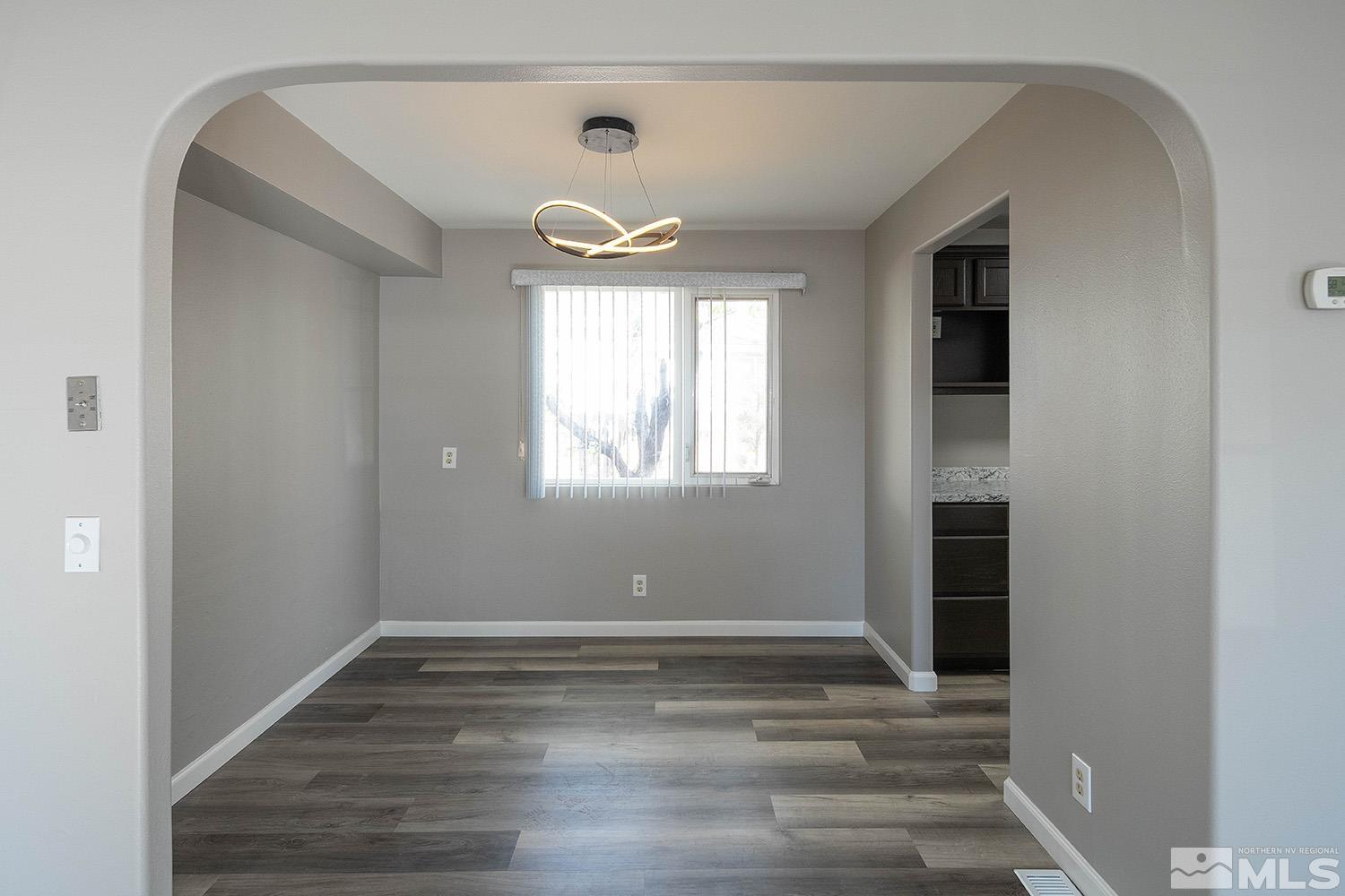 16310 Enargite Circle Reno, NV 89521 - Photo 7 of 32 a view of empty room with wooden floor and fan