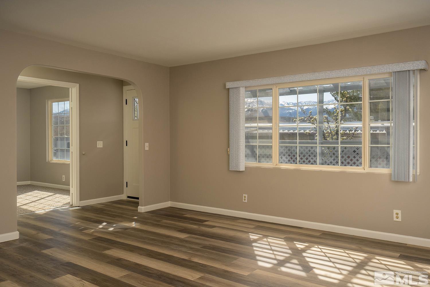 16310 Enargite Circle Reno, NV 89521 - Photo 10 of 32 a view of an empty room with wooden floor and a window