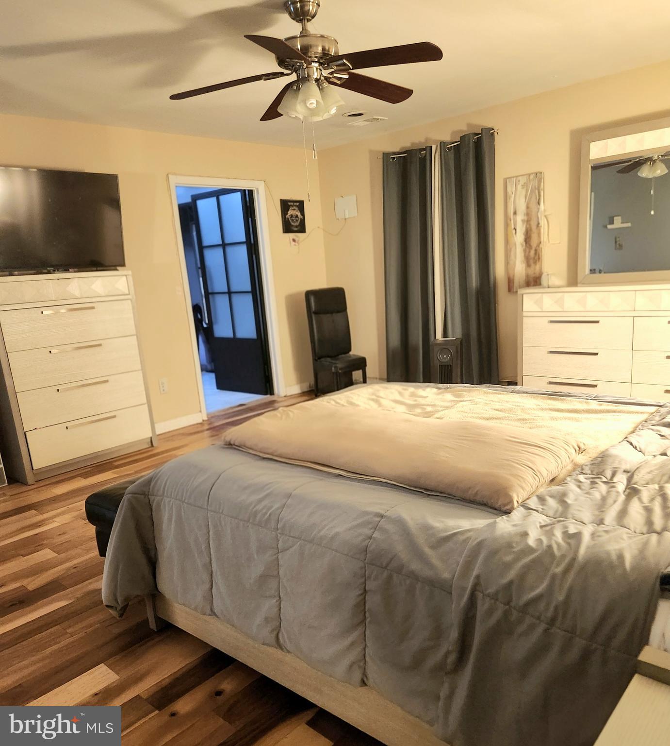 6810 Robinia Road Temple Hills, MD 20748 - Photo 13 of 15 a bedroom with a bed and a flat tv screen on dresser