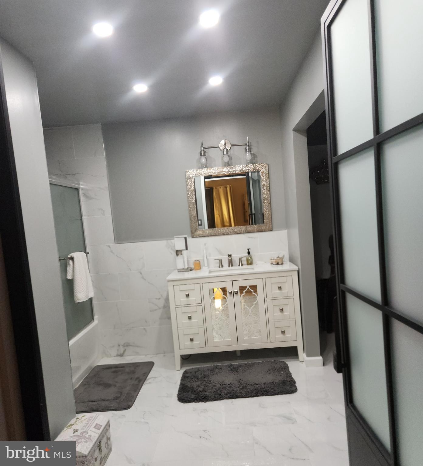 6810 Robinia Road Temple Hills, MD 20748 - Photo 15 of 15 a bathroom with a sink a large mirror and a toilet