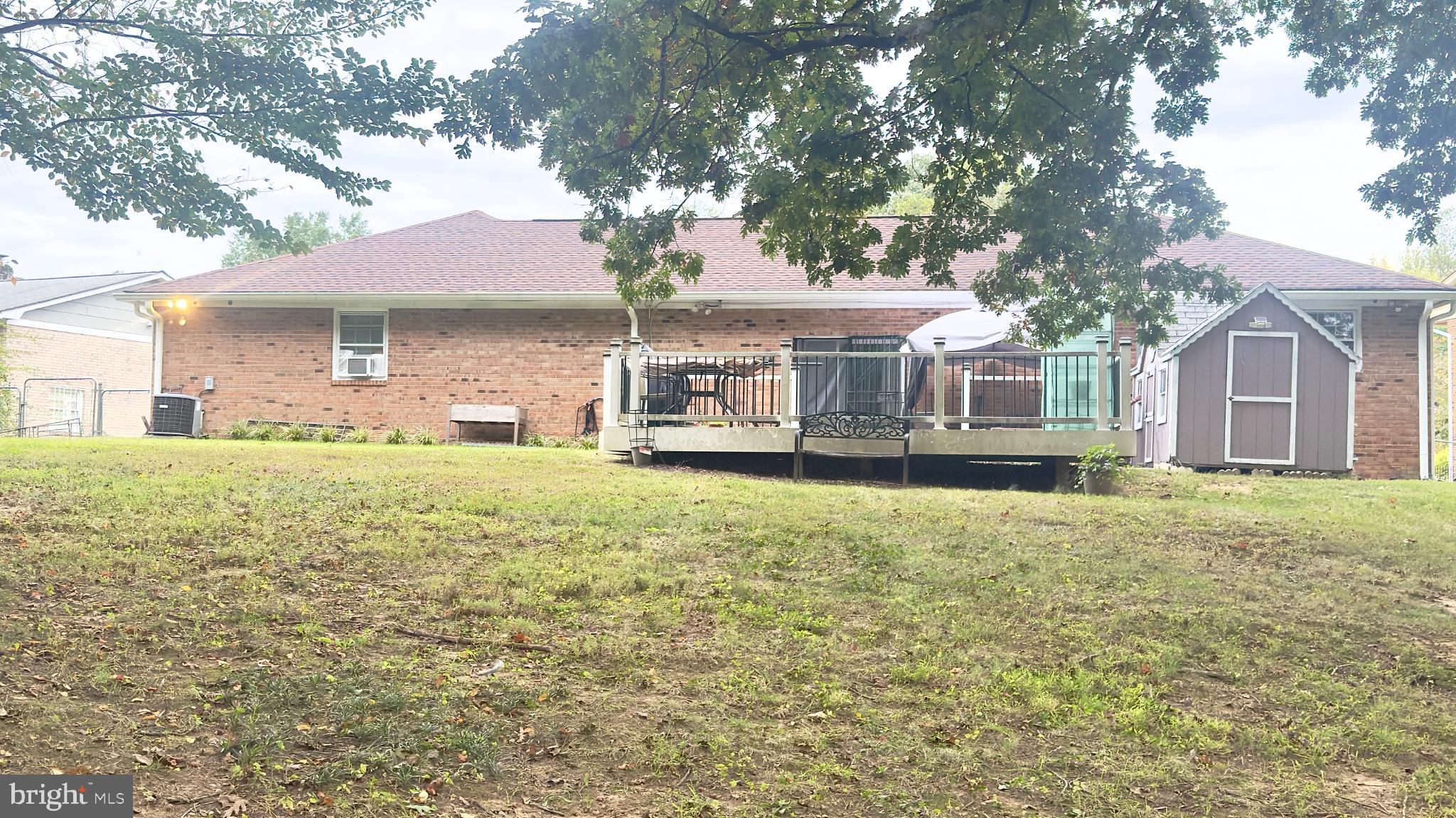 6810 Robinia Road Temple Hills, MD 20748 - Photo 3 of 15 a front view of a house with a garden