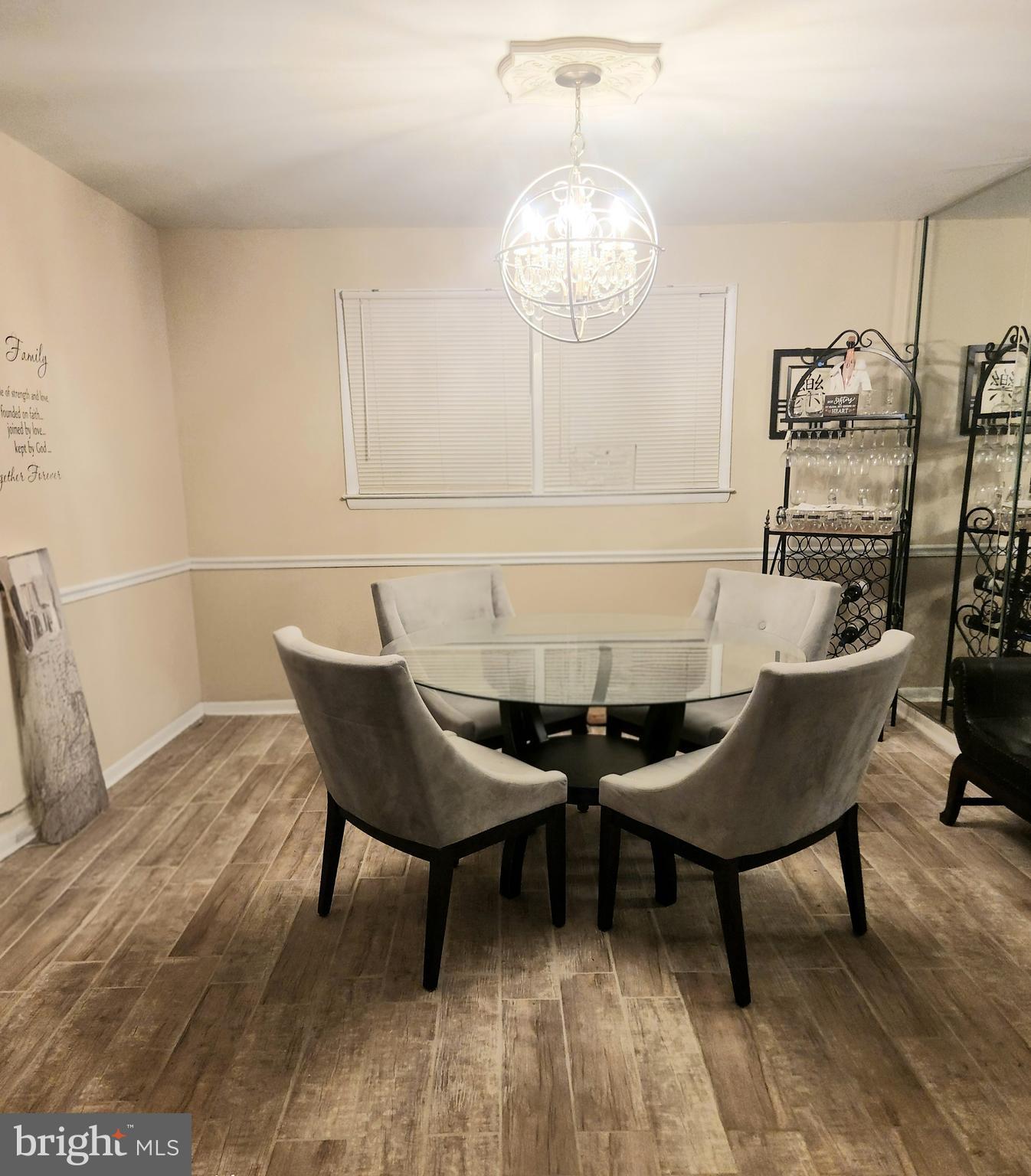 6810 Robinia Road Temple Hills, MD 20748 - Photo 10 of 15 a view of a dining room with furniture and chandelier