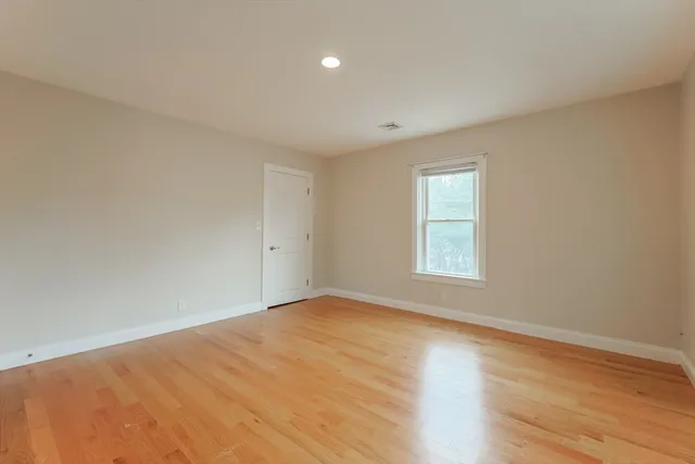 a view of an empty room and wooden floor