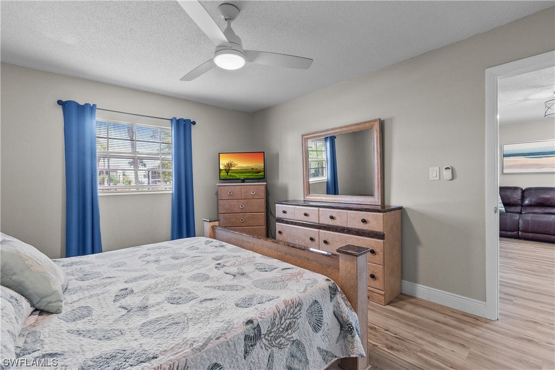 7031 New Post Road, Unit 4 North Fort Myers, FL 33917 - Photo 12 of 39 a bedroom with a bed and a dresser
