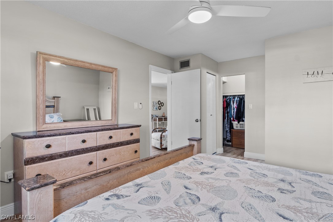 7031 New Post Road, Unit 4 North Fort Myers, FL 33917 - Photo 13 of 39 a bedroom with a bed and a mirror on dresser