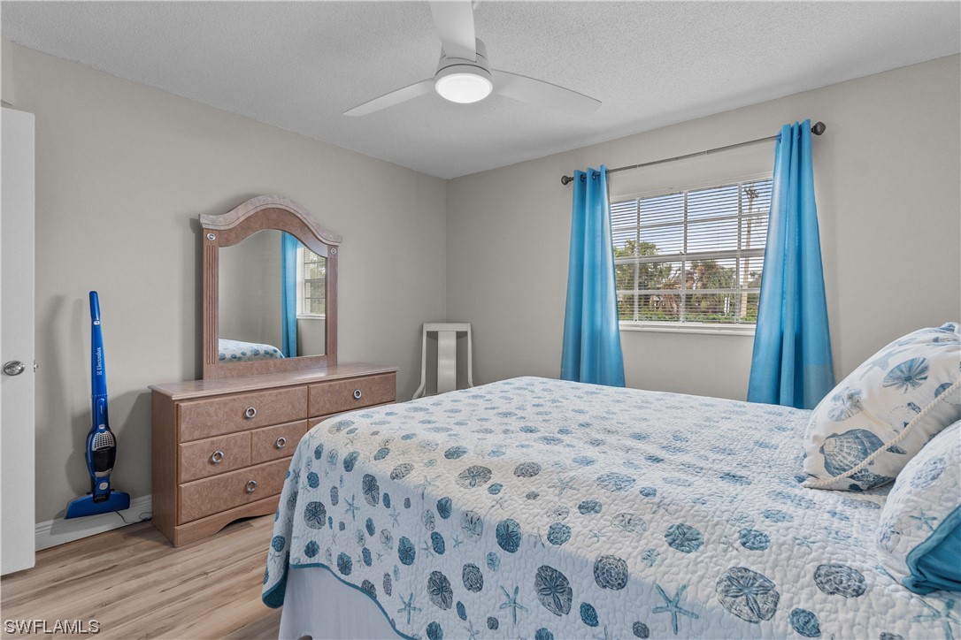 7031 New Post Road, Unit 4 North Fort Myers, FL 33917 - Photo 17 of 39 a bedroom with a bed and a dresser with mirror