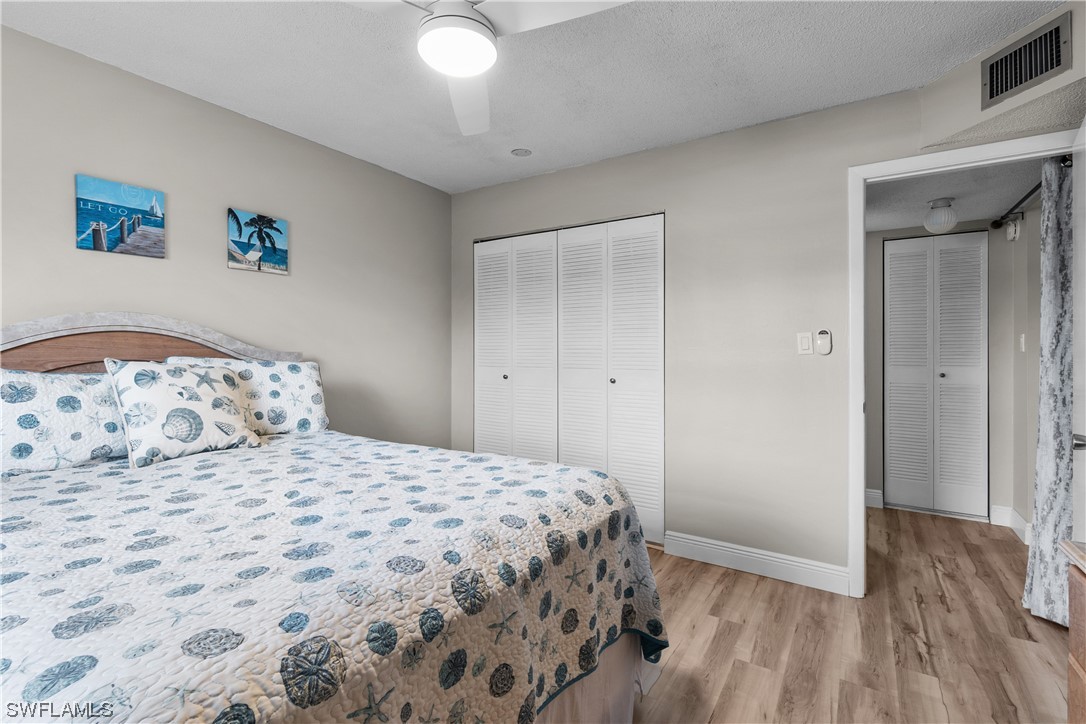 7031 New Post Road, Unit 4 North Fort Myers, FL 33917 - Photo 19 of 39 a bedroom with a bed and a view of bathroom