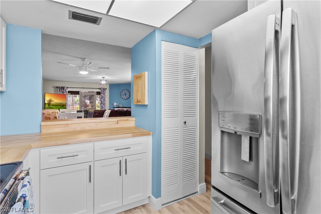 7031 New Post Road, Unit 4 North Fort Myers, FL 33917 - Photo 2 of 39 a kitchen with kitchen island a counter top space a sink and refrigerator