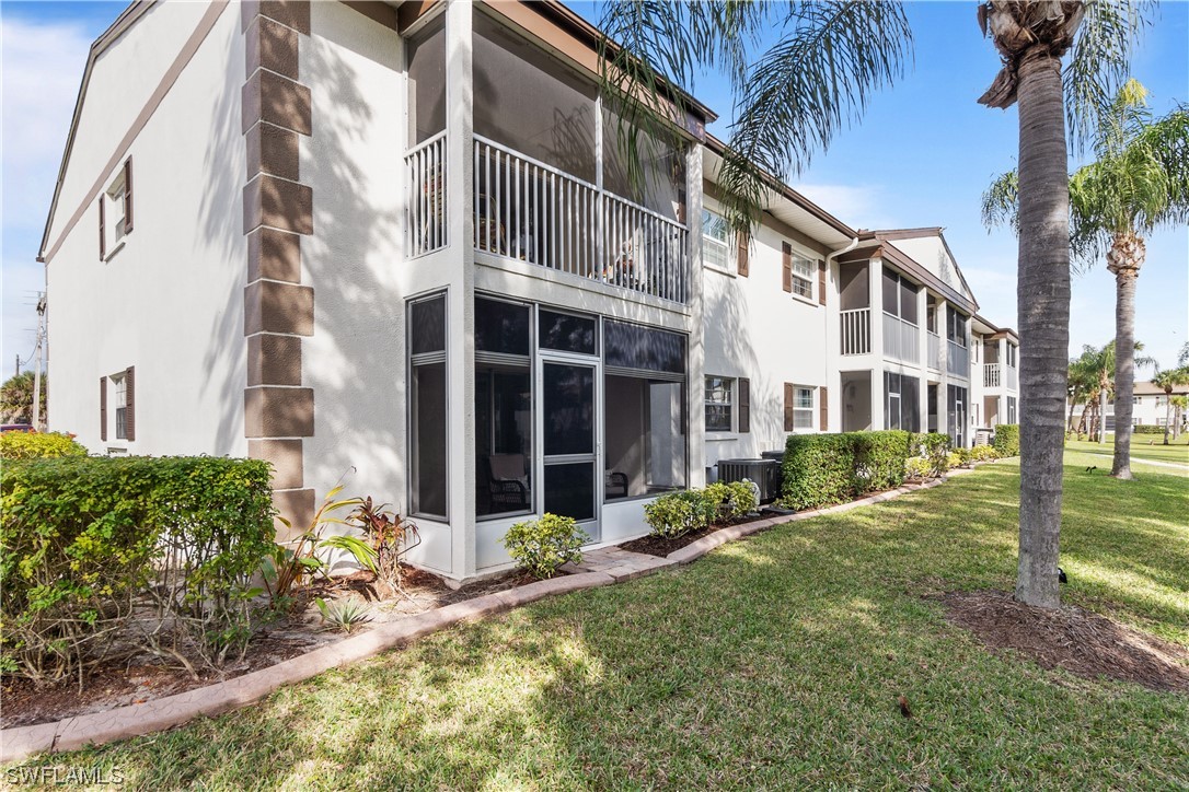 7031 New Post Road, Unit 4 North Fort Myers, FL 33917 - Photo 23 of 39 a front view of a house with a yard