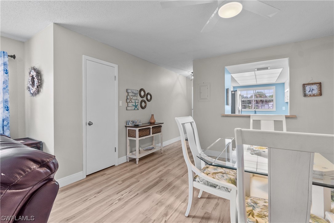 7031 New Post Road, Unit 4 North Fort Myers, FL 33917 - Photo 4 of 39 a living room with furniture and a table