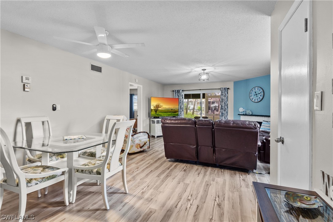 7031 New Post Road, Unit 4 North Fort Myers, FL 33917 - Photo 5 of 39 a view of a dining room with furniture and wooden floor