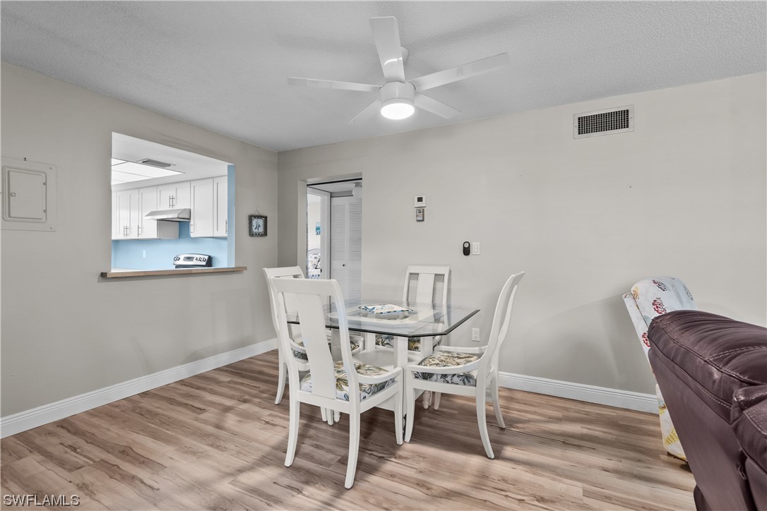 7031 New Post Road, Unit 4 North Fort Myers, FL 33917 - Photo 6 of 39 a view of a dining room with furniture and wooden floor