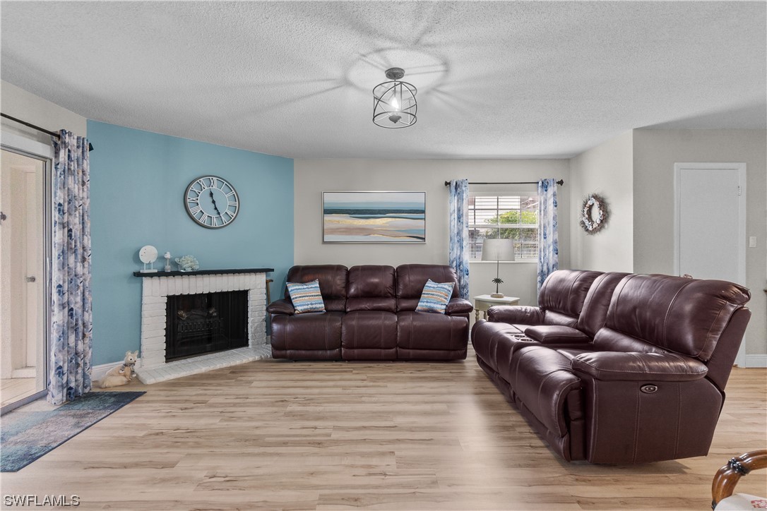 7031 New Post Road, Unit 4 North Fort Myers, FL 33917 - Photo 7 of 39 a living room with furniture and a fireplace