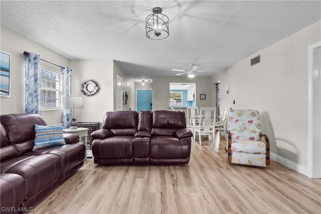 7031 New Post Road, Unit 4 North Fort Myers, FL 33917 - Photo 9 of 39 a living room with furniture and a window