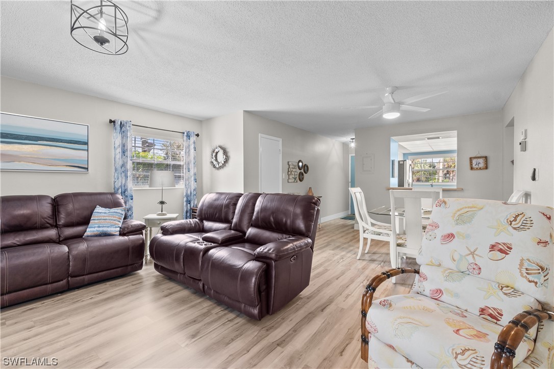 7031 New Post Road, Unit 4 North Fort Myers, FL 33917 - Photo 10 of 39 a living room with furniture and a wooden floor