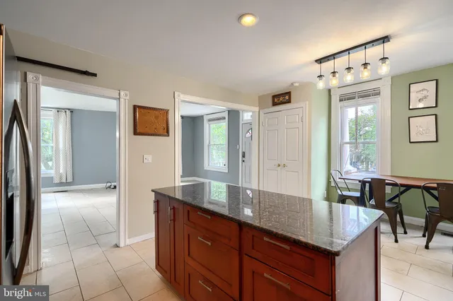 a kitchen with granite countertop a table and chairs