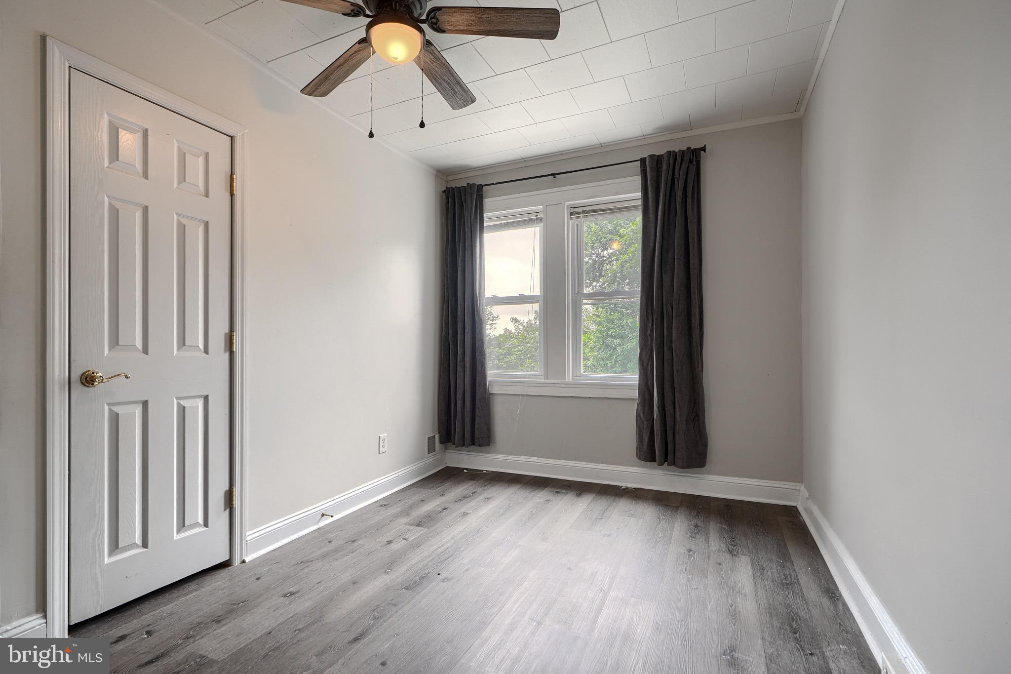 620 Montpelier Street, Unit 1 Baltimore, MD 21218 - Photo 27 of 29 a view of empty room with wooden floor and fan