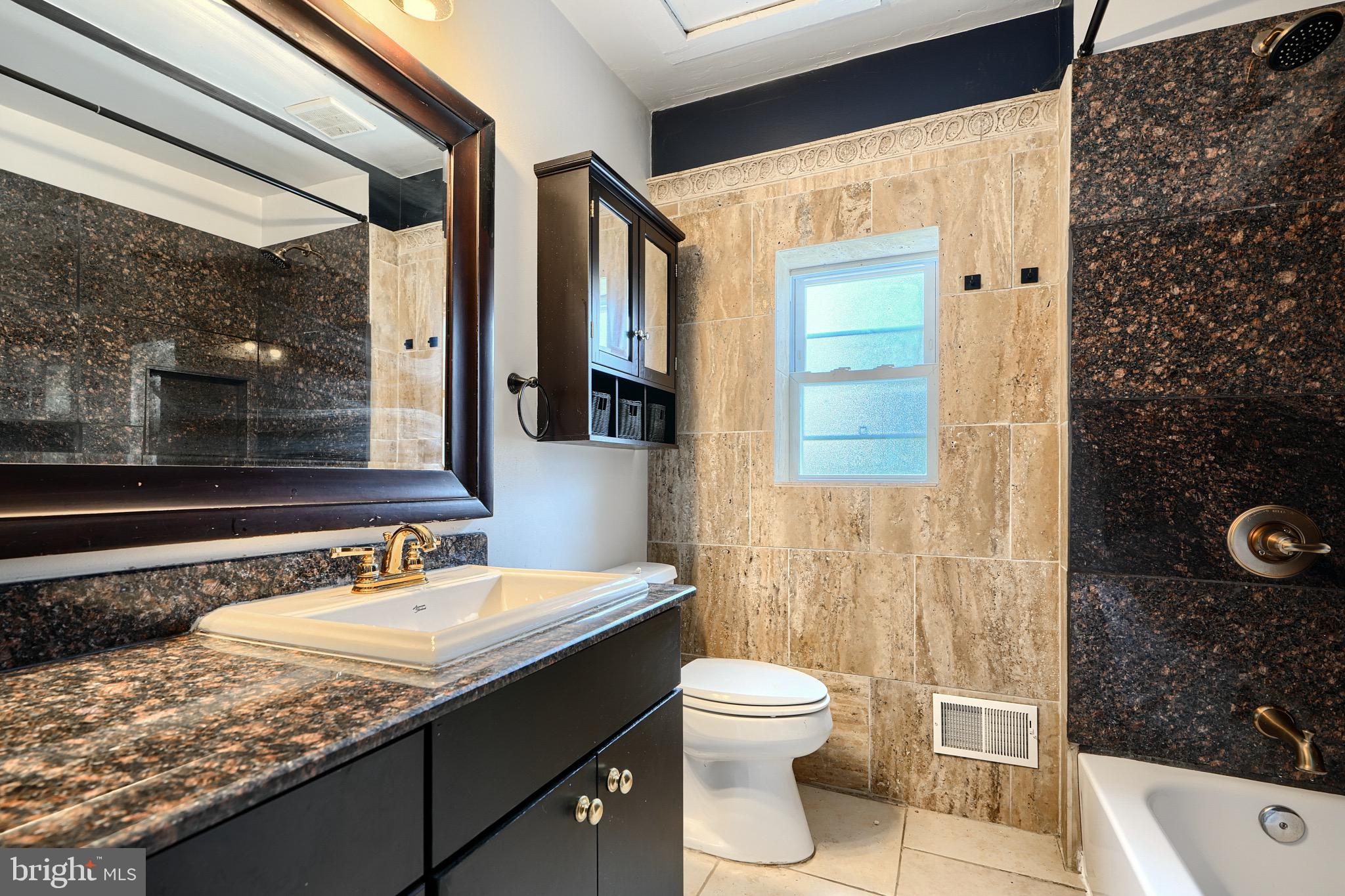 620 Montpelier Street, Unit 1 Baltimore, MD 21218 - Photo 28 of 29 a bathroom with a sink a toilet and shower