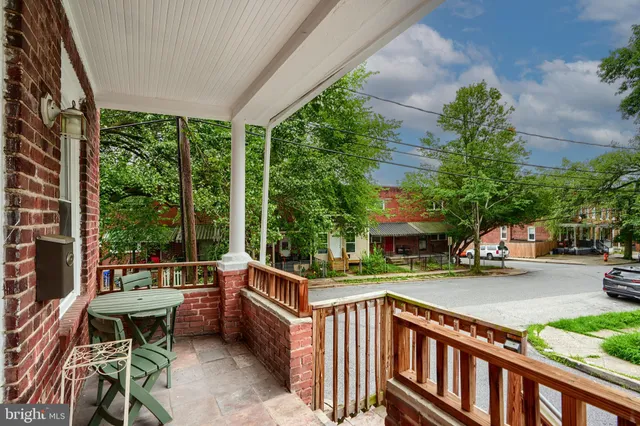 a balcony with outdoor seating and plants