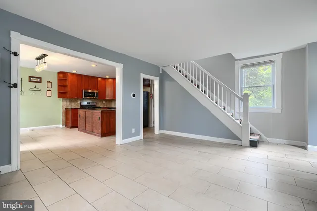 a view of a livingroom with kitchen and furniture
