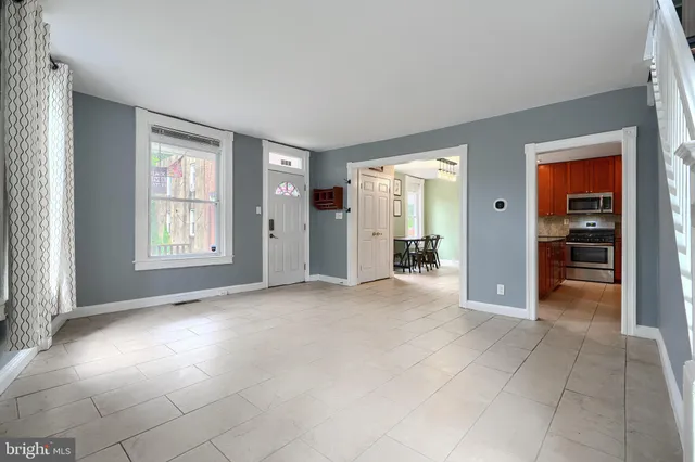 an empty room with windows and closet