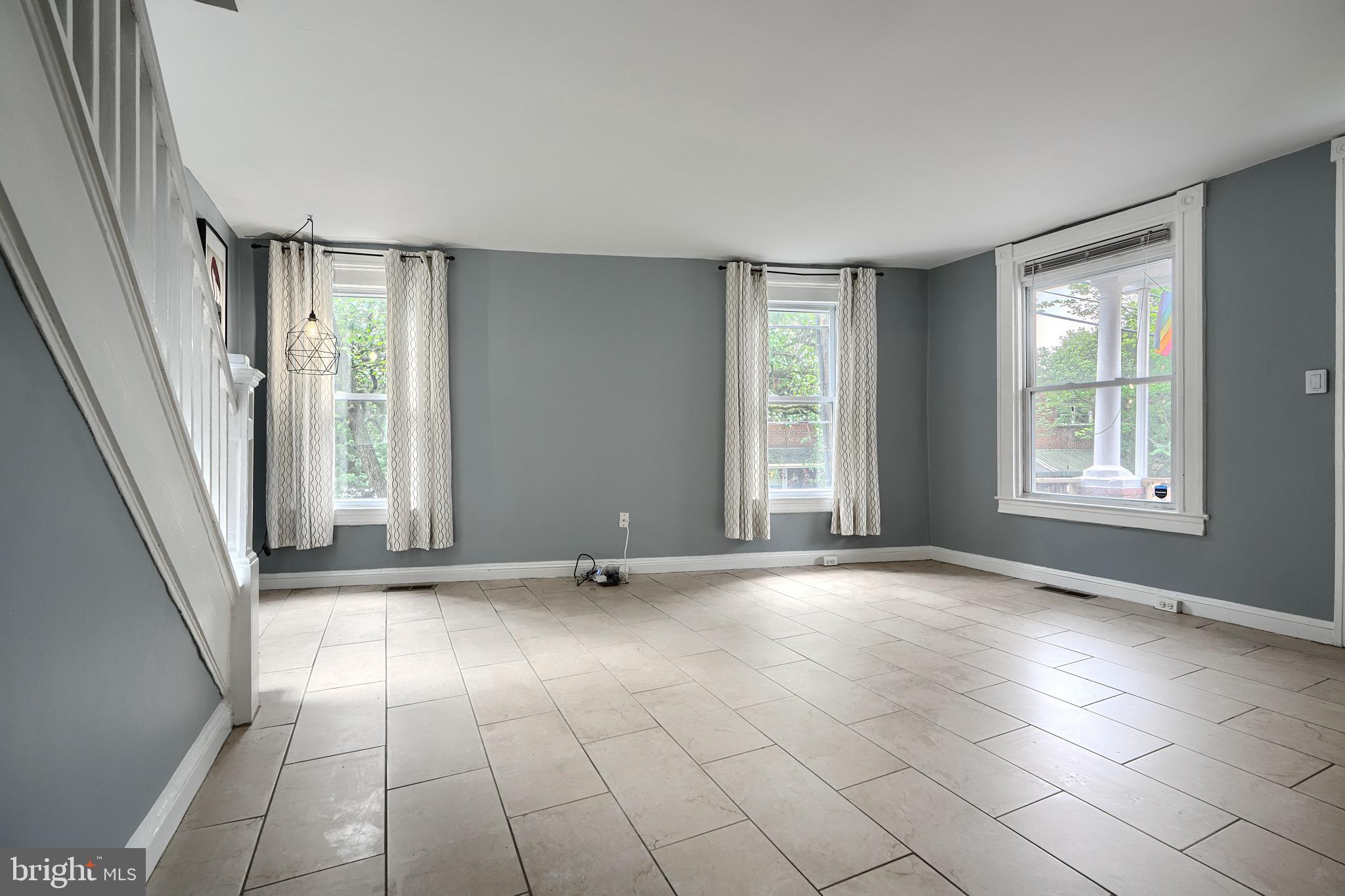 620 Montpelier Street, Unit 1 Baltimore, MD 21218 - Photo 6 of 29 a view of an empty room with window and chandelier fan