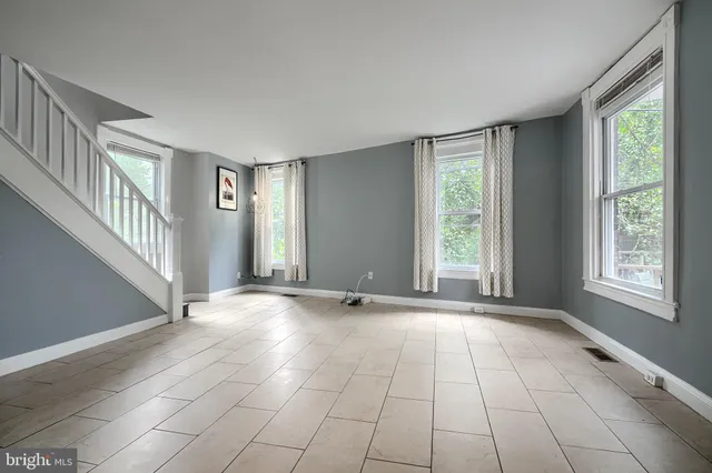 a view of an empty room with windows