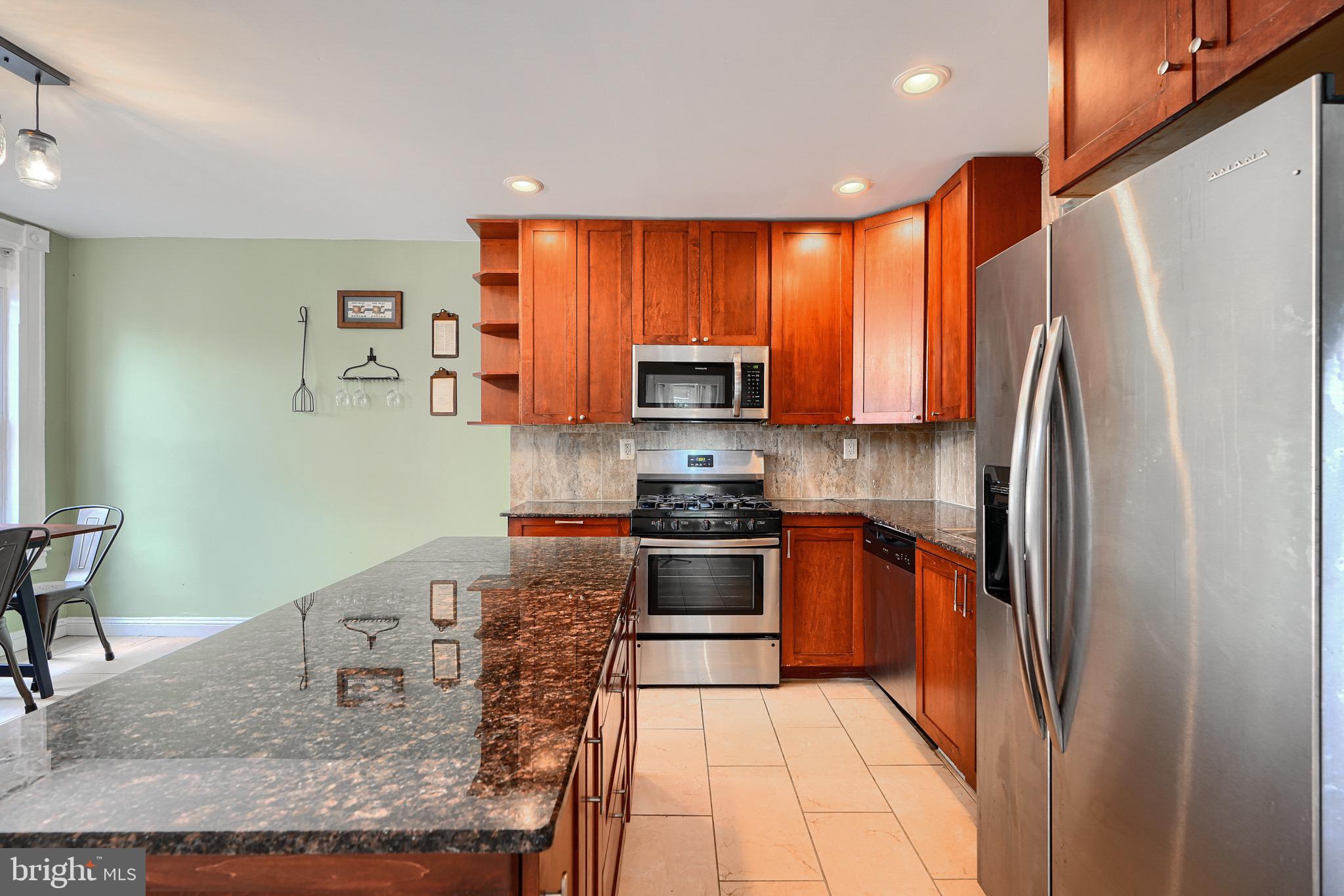 620 Montpelier Street, Unit 1 Baltimore, MD 21218 - Photo 9 of 29 a kitchen with stainless steel appliances granite countertop a refrigerator sink and stove
