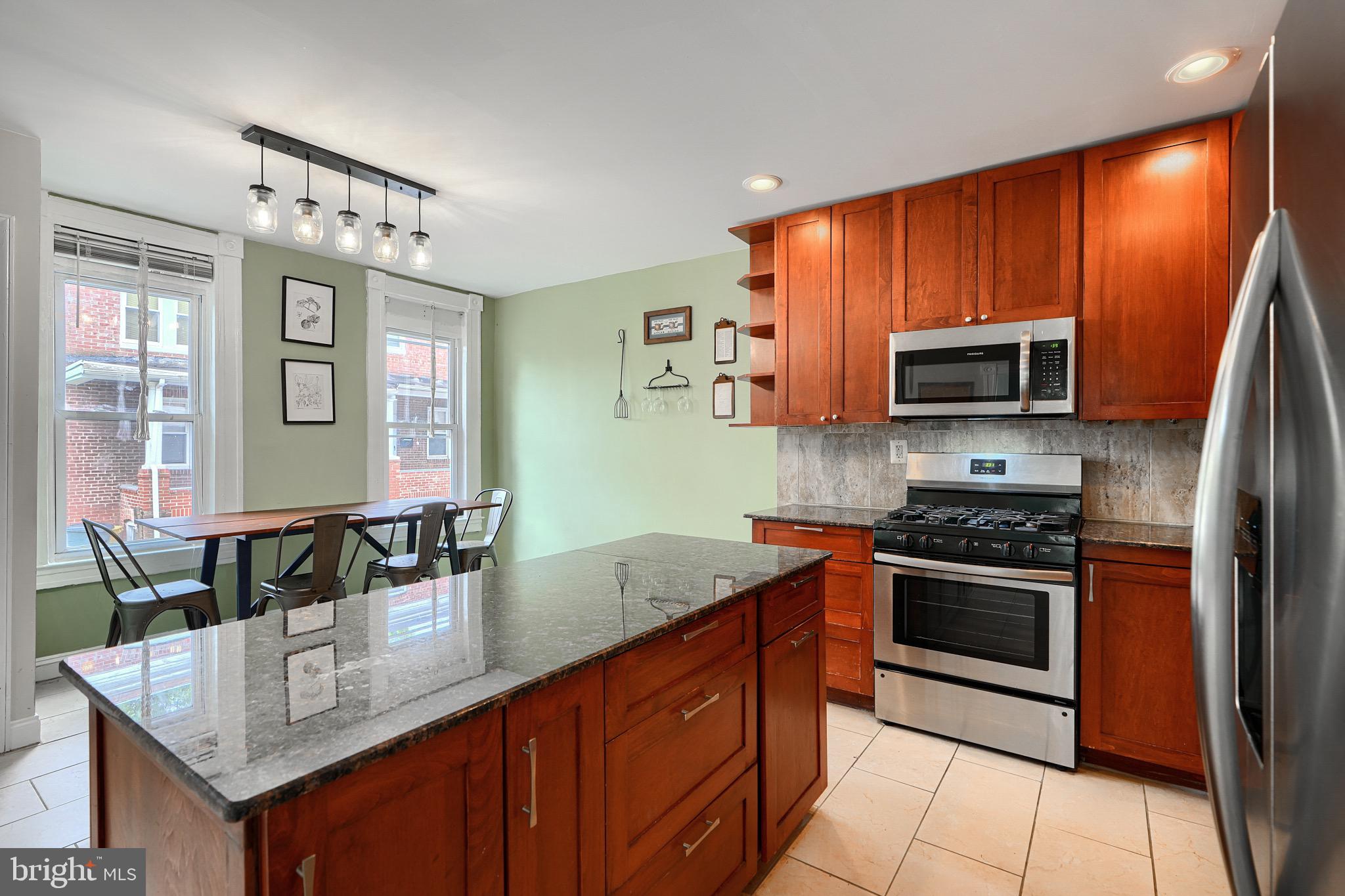 620 Montpelier Street, Unit 1 Baltimore, MD 21218 - Photo 10 of 29 a kitchen with stainless steel appliances granite countertop a stove microwave and sink