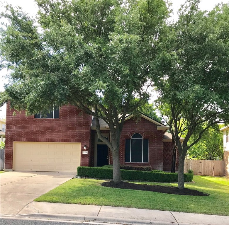 2334 Candle Ridge Trail Georgetown, TX 78626 - Photo 1 of 1 a front view of a house with a garden and tree